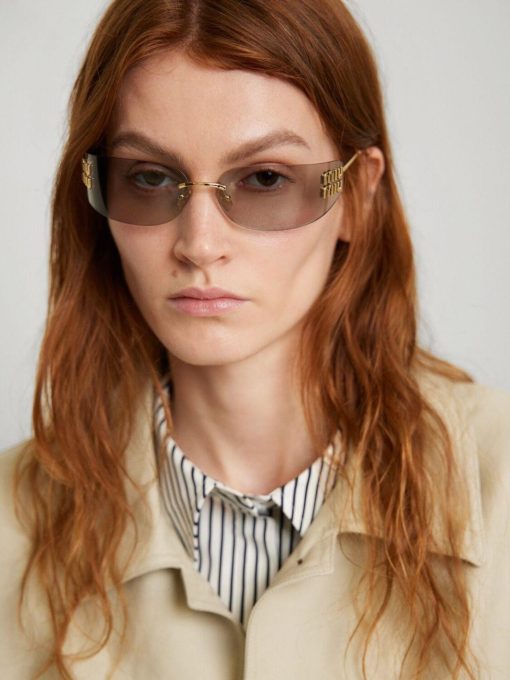MIU MIU. Provides full protection against UVA and UVB. Irregular-shaped. Women's sunglasses. In gold color. - Image 7
