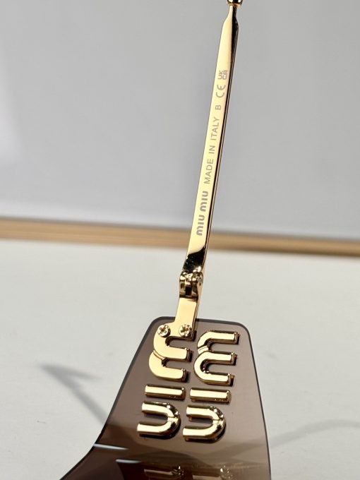 MIU MIU. Provides full protection against UVA and UVB. Irregular-shaped. Women's sunglasses. In gold color. - Image 2